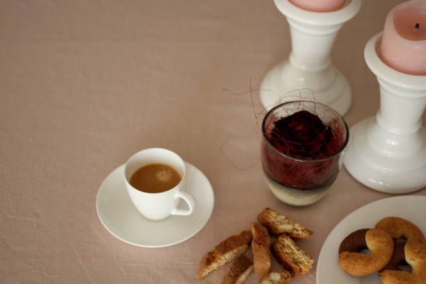 istock Romantic table with candles, red rose, plate, coffee and biscuits 914594412
