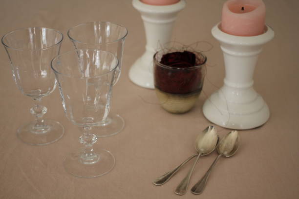 istock Romantic table with candles, red rose, plate, empty wine glasses and coffee spoons 914594516