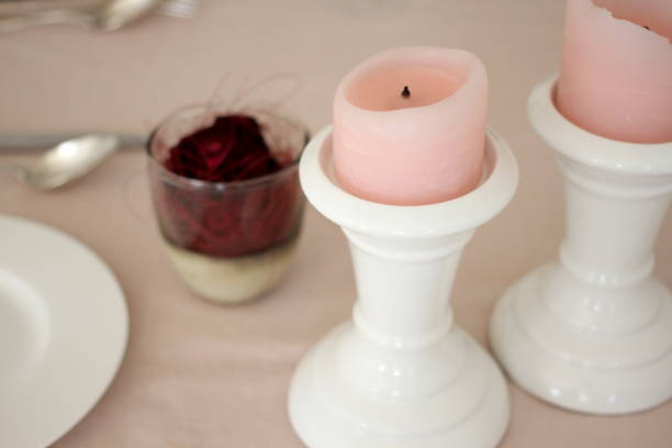 istock Romantic table with candles, red rose, plate and cutlery 914594570