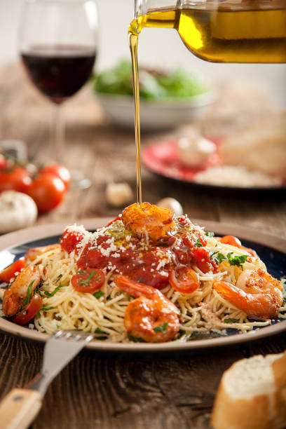 istock Spaghetti with shrimps, salad and olive oil 914599470