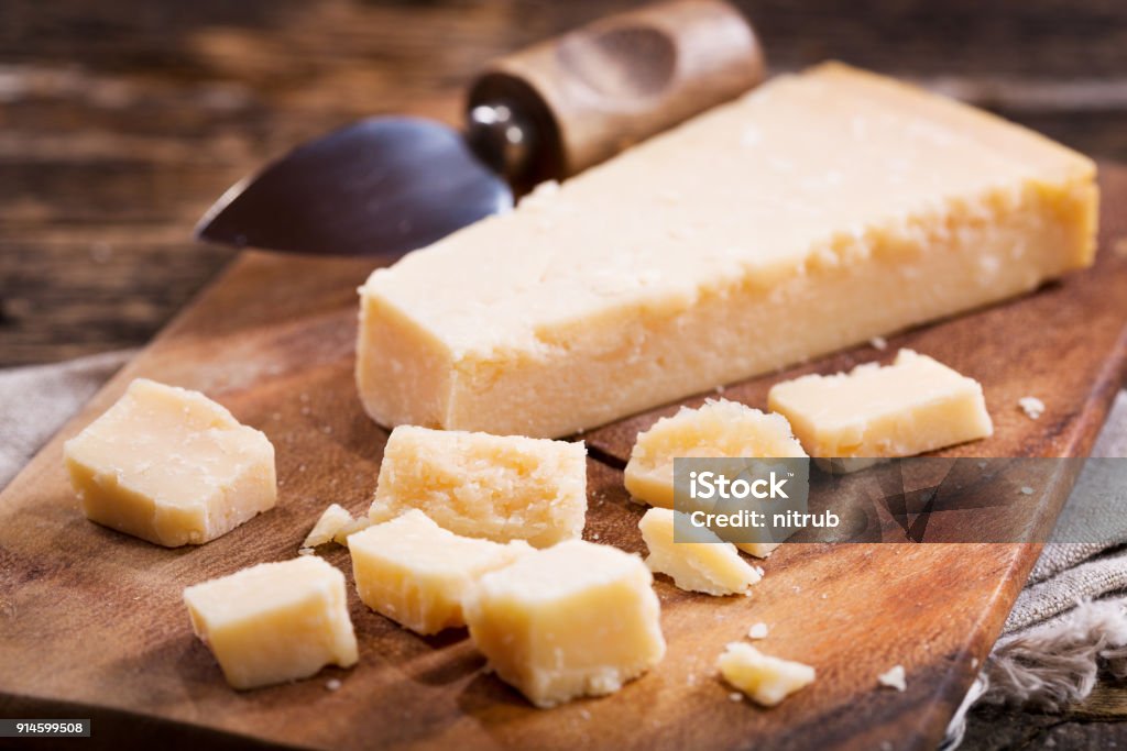Pieces of parmesan cheese Parmesan cheese on a wooden board Parmesan Cheese Stock Photo