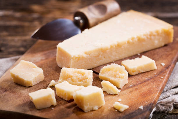 Pieces of parmesan cheese Parmesan cheese on a wooden board parmesan stock pictures, royalty-free photos & images