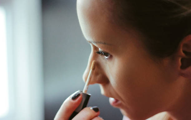 istock Young women applied concealer under the eyes 914605728