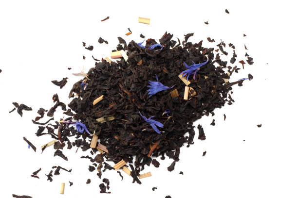 istock Aromatic black dry tea with petals isolated on white background top view 914609704