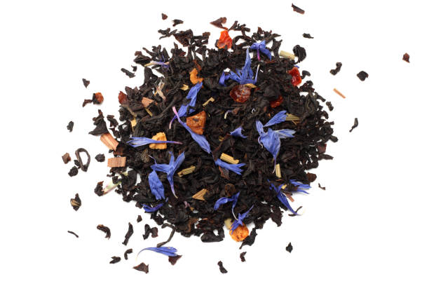 istock Aromatic black dry tea with petals isolated on white background top view 914609722