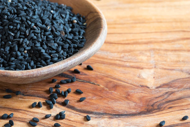 istock Black cumin seeds on a wooden spoon with copy space 914612136
