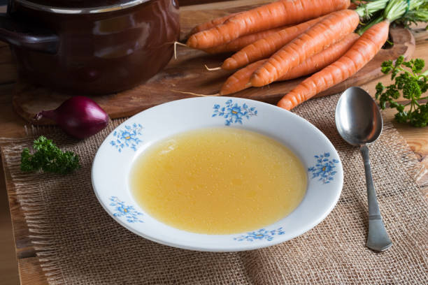 istock Chicken stock in a plate on a wooden table 914612168