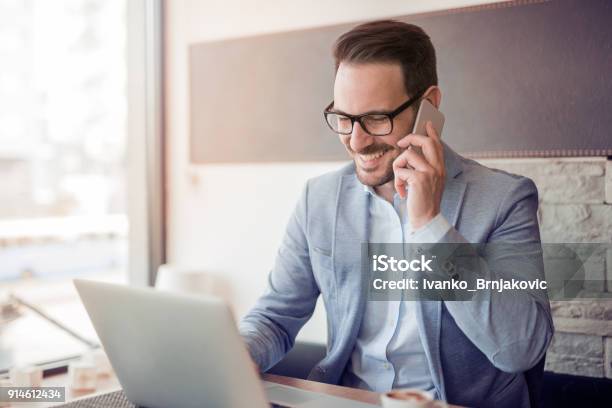 Portrait Of Handsome Young Businessman Stock Photo - Download Image Now - Using Phone, Businessman, Business