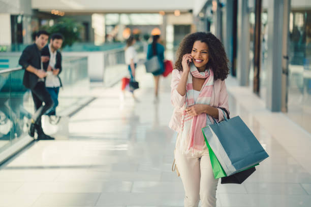 Shopaholic girl on shopping Guys looking at beautiful woman in the shopping mall mall walker stock pictures, royalty-free photos & images