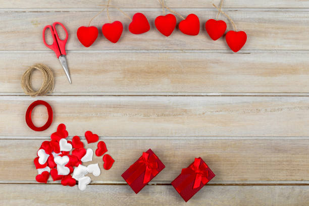 istock Valentine day background hearts on wooden table 914613394