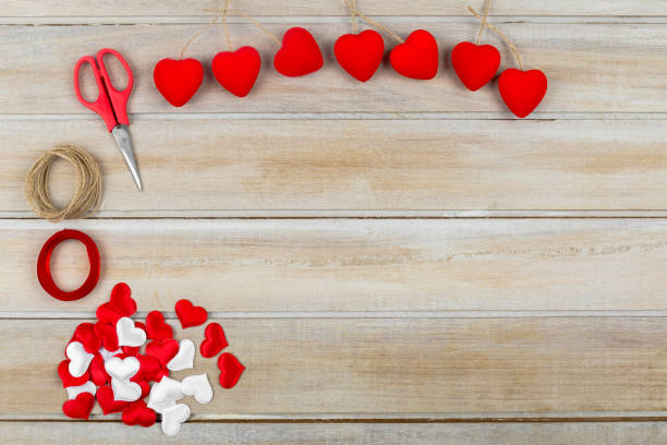 istock Valentine day background hearts on wooden table 914613628
