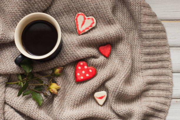 istock Cup of coffee and two heart shape cookies gingerbread 914613784