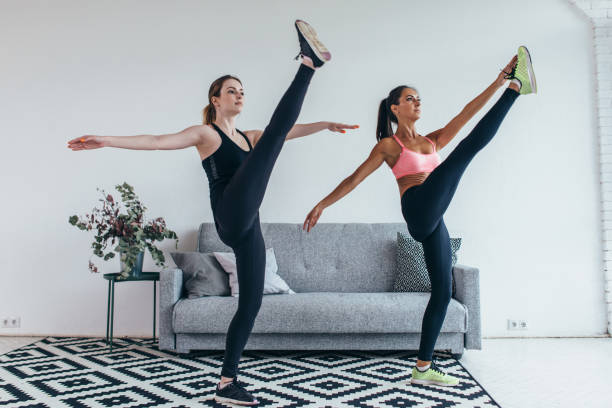 istock Fit woman stretching legs warming up workout at home 914616424