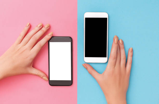 istock female hands hold two phones black and white 914616668