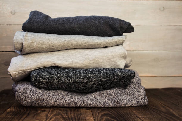 istock a stack of sweter on a wooden background 914617558