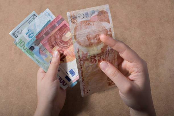 istock Hand holding American dollar  isolated on wooden background 914619842