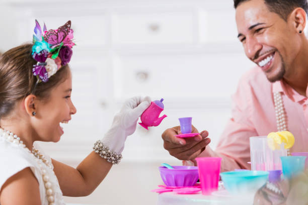 istock Father and daughter having tea party 914620272