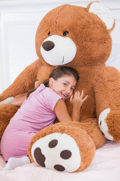 istock Little girl with giant teddy bear 914620698