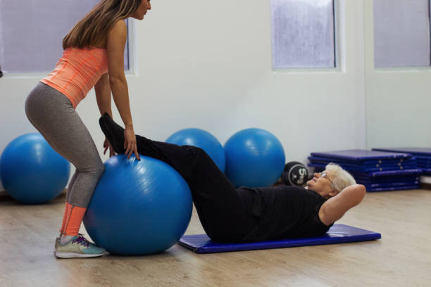 istock Older woman exercises in the gym 914621032