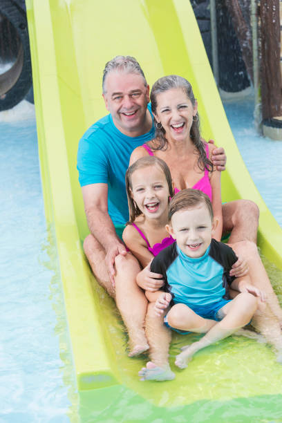 istock Two children with grandparents on water slide 914621492