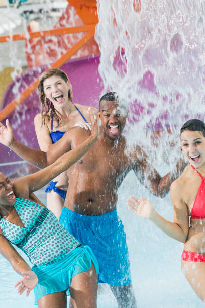 istock Multi-ethnic adult friends having fun at water park 914622530