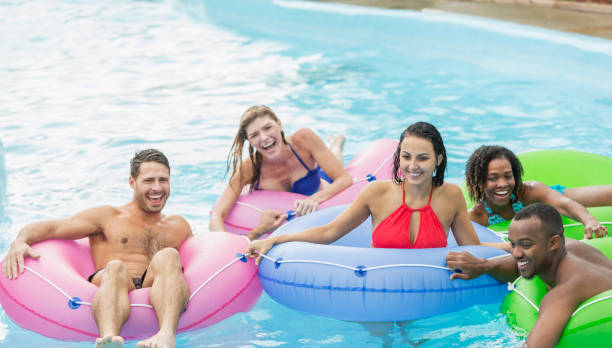 istock Multi-ethnic group of friends on inflatable rings 914622632