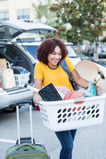 Photo of Young African-American woman moving house