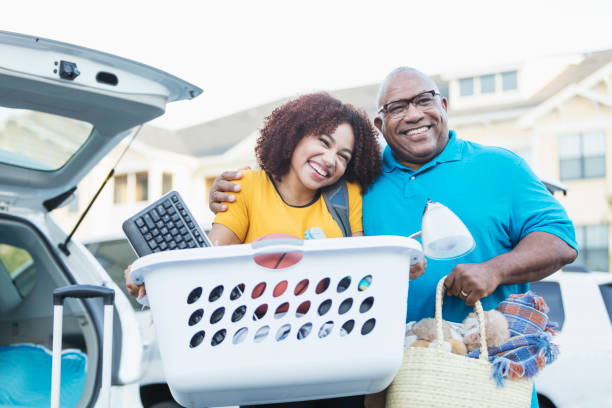 istock African-American father helping daughter move 914625220