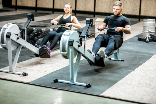 istock Couple training with exercise machines in the gym 914625296
