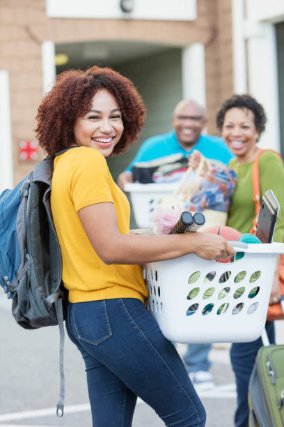 istock African-American parents helping daughter move 914625450