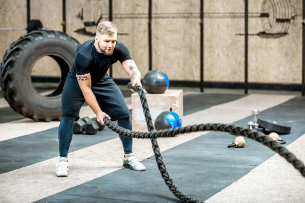 istock Man training with a rope in the gym 914625956