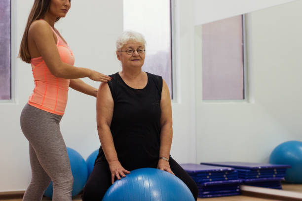 istock Older woman exercises in the gym 914628126