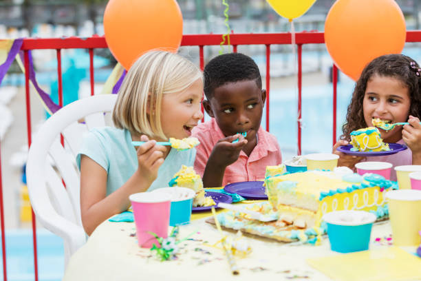 istock Children at a birthday party eating cake 914628994