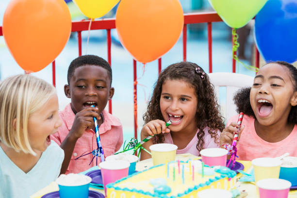 istock Children at birthday party with horns 914629194