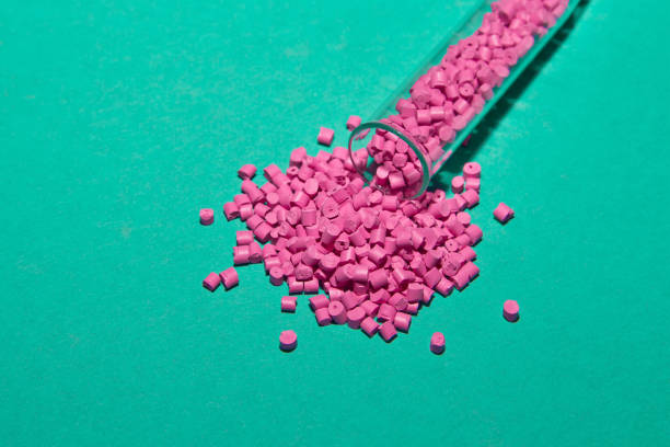 istock Plastic pallets . Plastic raw materials in granules for industry. Polymeric dye pink on a turquoise background. Plastic granules after processing of waste polyethylene and polypropylene.Polymer. 914629396