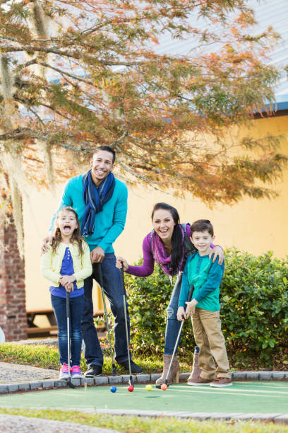 istock Family playing miniature golf 914630934