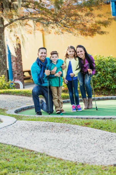istock Family playing miniature golf 914630940