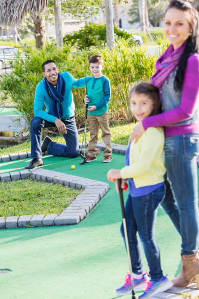 istock Family playing miniature golf, focus on father and son 914633030