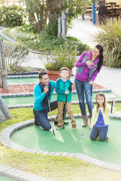 istock Family playing miniature golf 914633032