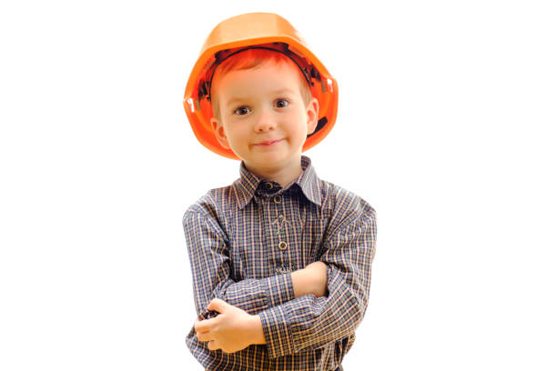 istock Concept, small smiling boy with construction helmet, looks afar isolated on white background with copy space 914633392