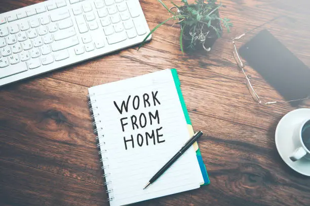 Photo of notebook  written work from home text