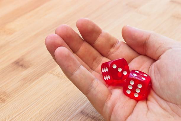 istock A hand holding red dice. This image can be use to represent gambling or risk taking. 914640542