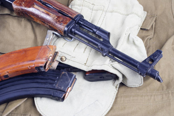 istock AK47 on USSR Soviet Army khaki uniform background 914640594