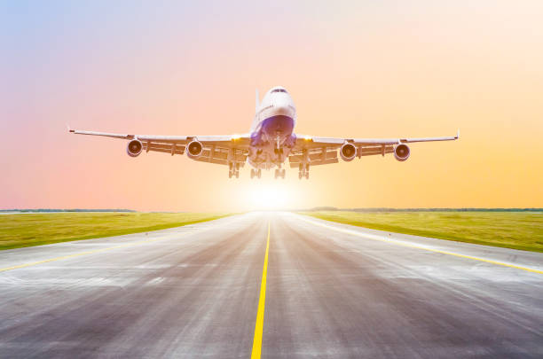 istock Large passenger plane take off from the runway before the light from the sunshine. 914640792