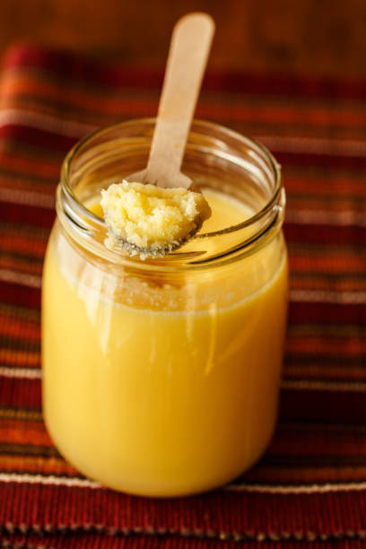 Ghee/clarified butter Homemade Ghee/clarified butter in a glass jar ghee stock pictures, royalty-free photos & images