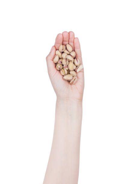 istock Female hand hold healthy bio pistachios nuts 914641330