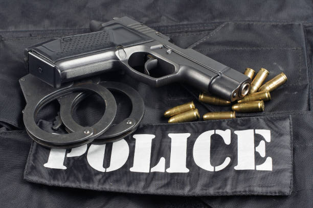 istock Police concept - handgun on black uniform background 914645264