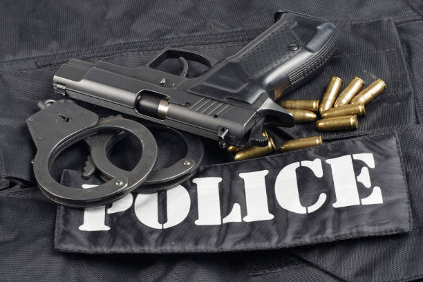 istock Police concept - handgun on black uniform background 914647574