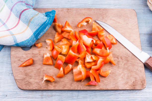 istock Sliced red pepper on a wooden board - top view 914647942