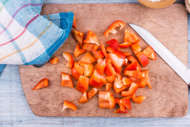 istock Sliced red pepper on a wooden board - top view 914647996
